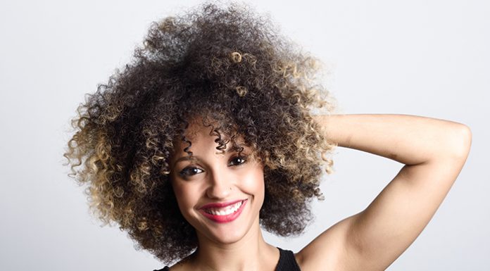 Curly Hair: Five Tips For Beautiful Tresses Beautiful smiling woman with curly hair
