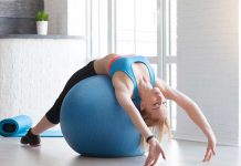 Fit sportswoman doing pilates with stability ball